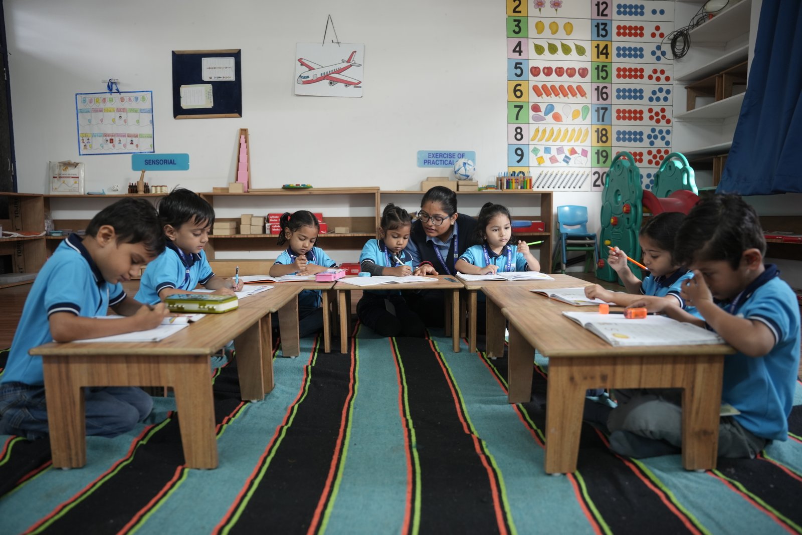 Children engaged with Montessori materials